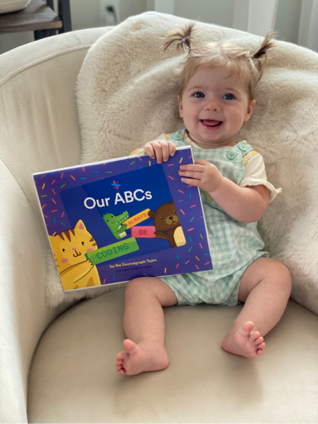 Baby holding a coding babybook